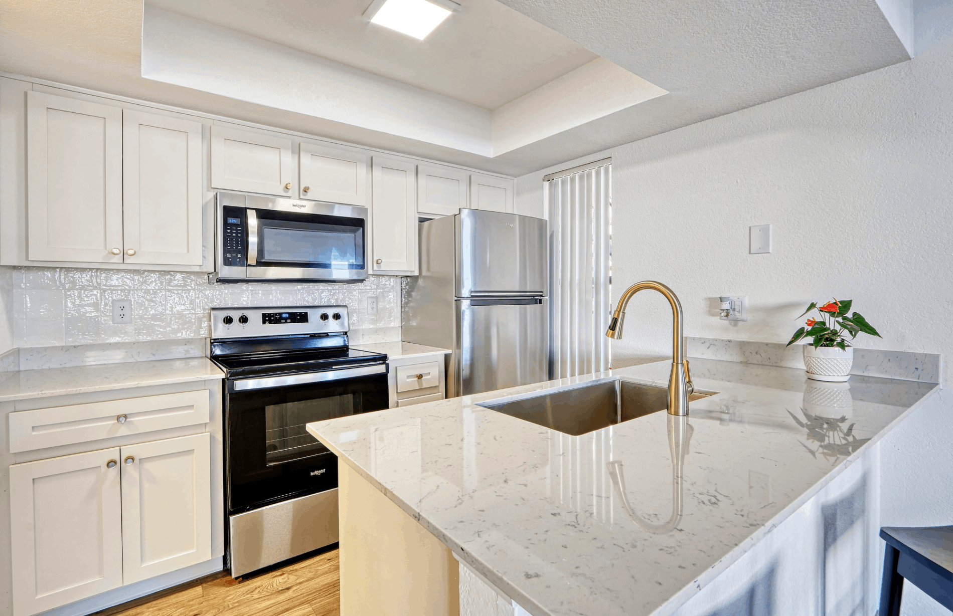 Renovated kitchen with stainless steel appliances and granite countertops